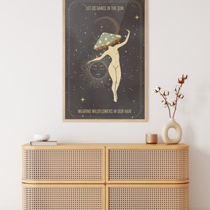 May include: A vintage-style poster with a dark background and stars. A woman with a mushroom on her head dances in front of a sun and moon. The text reads "Let us dance in the sun wearing wildflowers in our hair."