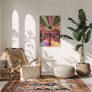 May include: A colourful psychedelic poster featuring a large eye in the centre, surrounded by rainbow stripes and a desert landscape. A person is walking towards the eye, with their reflection visible on the ground.