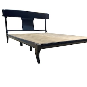 May include: A black wooden bed frame with a curved headboard and a wooden slatted base. The bed frame has a simple, elegant design and is supported by four legs.