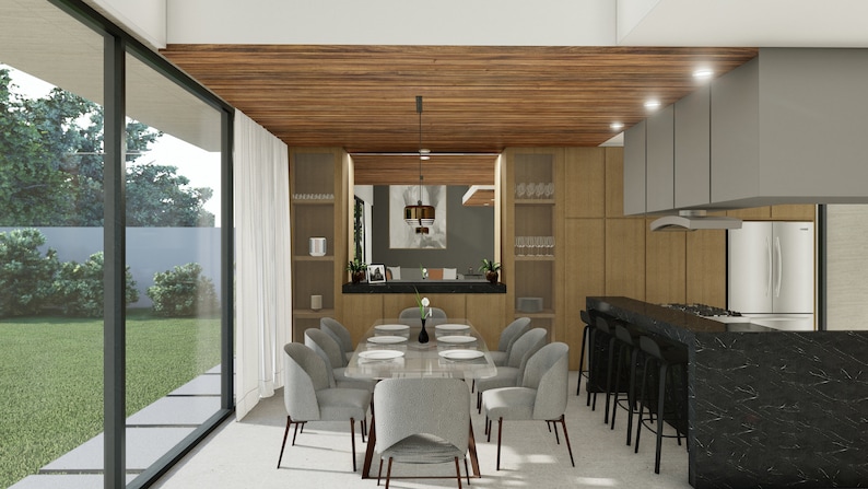Puede incluir: Vista interior de un comedor y una cocina modernos. El comedor cuenta con una mesa rectangular con sillas grises. La cocina tiene gabinetes de madera, una encimera negra y electrodom&eacute;sticos de acero inoxidable. Grandes ventanales ofrecen vistas al exterior.