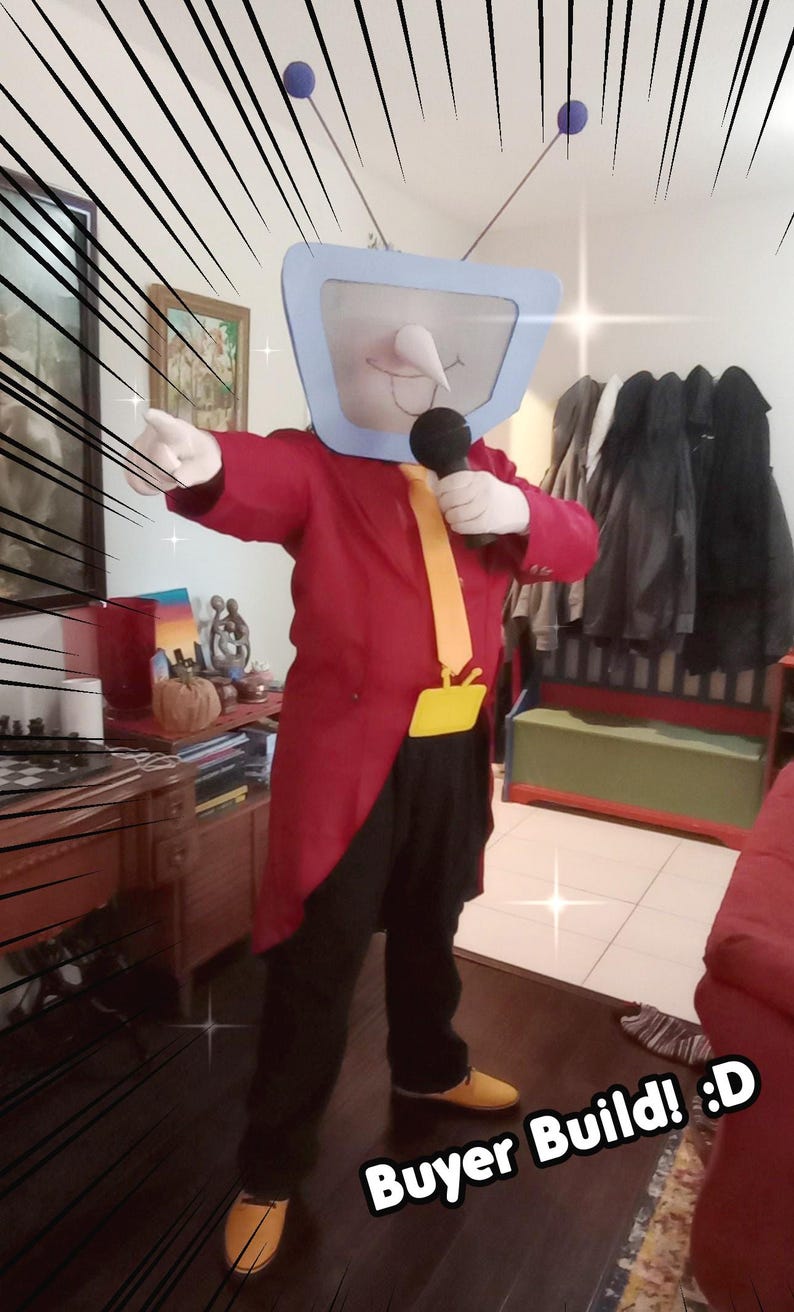 May include: A person in a TV-head costume, wearing a red tailcoat, black trousers, and yellow shoes. The costume includes a light blue TV screen head with antennas and a microphone. The text "Buyer Build! :D" is visible.