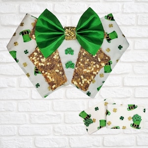 以下が含まれることがあります： 聖パトリックの日のペットアクセサリーセット。 金色のスパンコールセンターが付いた緑色のリボン、白と金の模様のビブ、お揃いのコースターが含まれています。 ビブには、レプラコーンの帽子とシャムロックのパターンがあります。