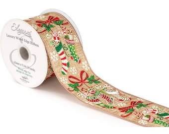 May include: A roll of Christmas-themed wired edge ribbon. The ribbon is beige with a festive pattern of red, green, and white candy canes, stockings, and snowflakes. The spool reads "Eleganz Luxury Wired Edge Ribbon", 63mm x 9.1m (10 yards).