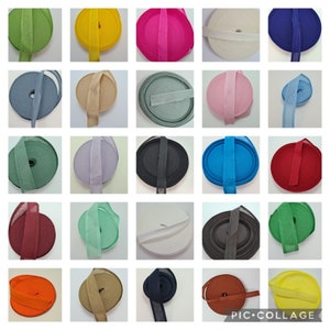 May include: A collection of 25 rolls of fabric trim in various colors, including red, blue, green, yellow, white, black, and brown. The trim is made of a soft, woven fabric and is perfect for adding a decorative touch to crafts, clothing, and home decor projects.