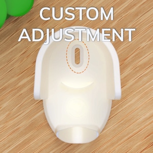 May include: White plastic wall mount with a round hole in the center. The text "CUSTOM ADJUSTMENT" is printed above the mount.