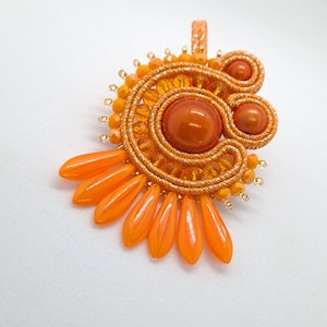 860. Orange soutache pendant decorated with magic pearls, faceted glass beads and Preciosa glass daggers