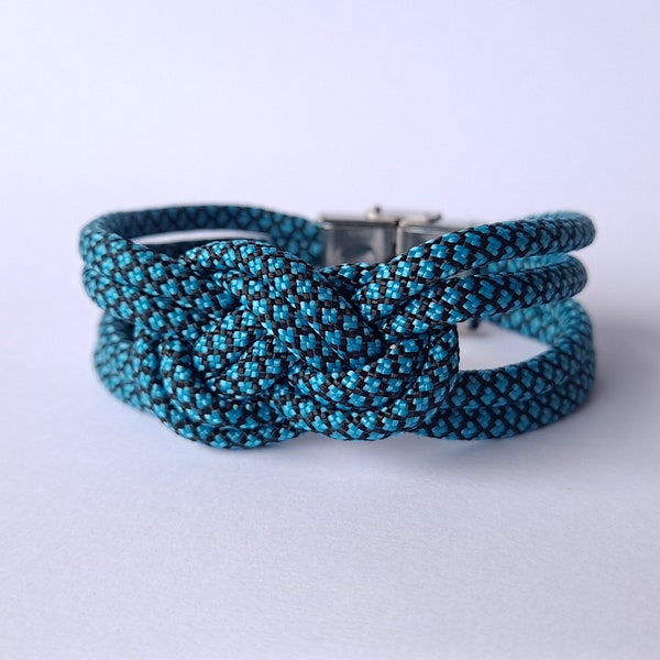 585. Bracelet en paracorde turquoise/bleu à motifs noirs avec tressage noeud marin