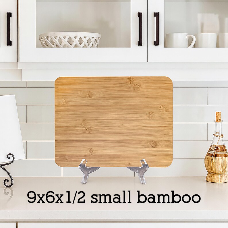 May include: A small, rectangular bamboo cutting board, measuring 9x6x1/2 inches, displayed on a countertop. The board has a natural wood grain pattern. The text "9x6x1/2 small bamboo" is printed at the bottom.