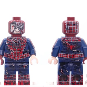 May include: A Lego minifigure of Spider-Man in a battle-damaged costume. The figure features a red and blue suit with a spiderweb design, and a partially unmasked face. The figure has a red head and arms, and a blue torso and legs.