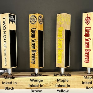 May include: Four wooden tap handles with different wood types and ink colours. The handles are labelled with the brewery names "Two House Brewing" and "Cheap Screw Brewery". The wood types are Maple, Wenge, Maple, and Maple. The ink colours are Black, Brown, Yellow, and Red.