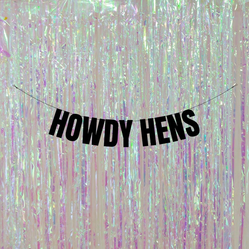 May include: Black banner with the text "Howdy Hens" hanging in front of a shimmering iridescent curtain.