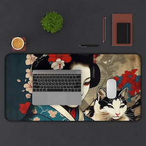 Puede incluir: Un tapete de ratón colorido con una geisha con un gato y flores de cerezo. La geisha lleva un kimono tradicional con acentos rojos y azules. El gato es negro y blanco con ojos verdes. El fondo es azul oscuro con un patrón floral.