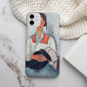 May include: A phone case featuring a painting of a woman in a white shirt with a red and white collar, holding a black and white object. The background is a light blue and white.