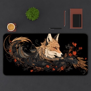 May include: A black and brown mousepad with a stylized illustration of a fox with orange fur and a black background. The fox is surrounded by intricate floral designs in shades of orange and brown.