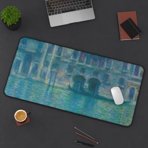 May include: A blue and green abstract painting of a canal scene with buildings and gondolas. The painting is on a black mouse pad.