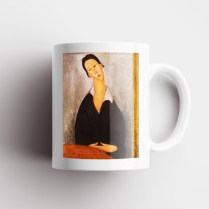 May include: White ceramic mug with a painting of a woman in a black dress and white collar. The woman has dark hair and is looking down. The background is a light gray with a gold frame.