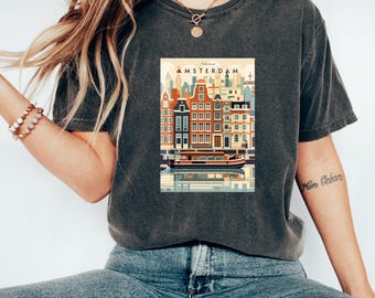 May include: A dark gray t-shirt with a vintage-style illustration of Amsterdam's canals and buildings. The text "Amsterdam" is printed in white above the illustration.