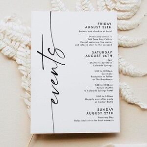 May include: A white event schedule card with black script. The card lists the events for Friday, August 25th, Saturday, August 26th, and Sunday, August 27th. The word "events" is written in cursive on the left side of the card.