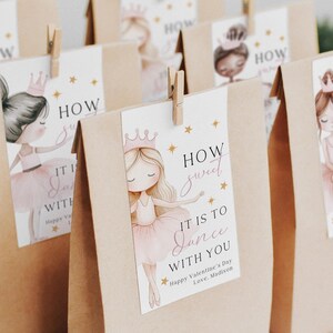 May include: Kraft paper gift bags with ballerina illustrations and the text "How sweet it is to dance with you." Each bag has a tag with a ballerina in a pink tutu, a crown, and gold stars.