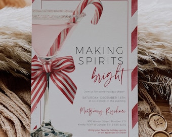 May include: A holiday invitation with a cocktail illustration. The invitation features a pink cocktail with a candy cane and a red and white striped bow. Text reads "MAKING SPIRITS bright".