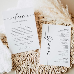 May include: Two white cards with black text. One says "welcome" and "family + friends" with a personal message. The other card says "events" and lists a schedule for Friday, Saturday, and Sunday. Both cards are on a woven mat.