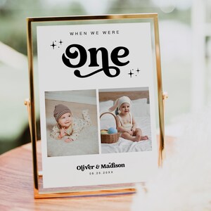 May include: A white sign with a gold frame, featuring the text "When we were one" in a black retro font with stars on either side. Two photos of babies are below the text, with the names "Oliver & Madison" and the date "08.26.20XX" below the photos.
