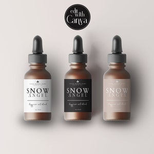 May include: Three brown glass dropper bottles with black droppers and labels that read "SNOW ANGEL" and "digginson oil blend". The bottles are arranged on a light background. The text "edit with Canva" is in the top left corner.