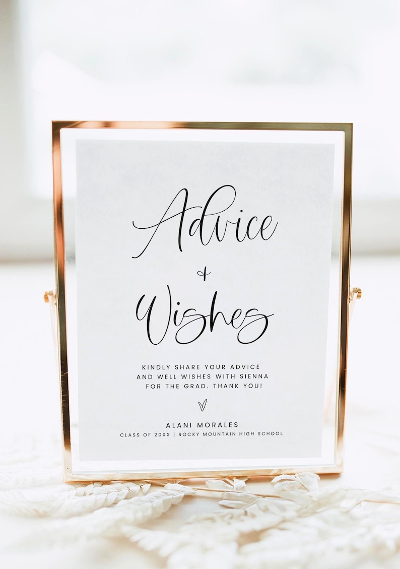 May include: A gold-framed sign with the words "Advice & Wishes" in elegant script. The sign includes a request to share advice and well wishes for a graduate, with the graduate's name and high school.