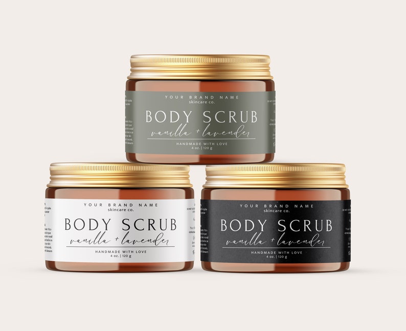 May include: Three amber glass jars with gold lids containing body scrub. Each jar has a label with the text "YOUR BRAND NAME skincare co. BODY SCRUB vanilla + lavender HANDMADE WITH LOVE 4 oz | 120g".
