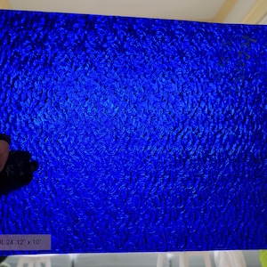 May include: A sheet of blue textured glass, measuring 24 inches by 12 inches by 10 inches.
