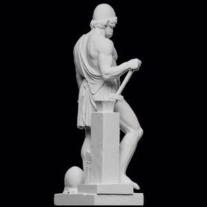 May include: White marble statue of a man holding a hammer, standing on a base with a round object at the bottom.