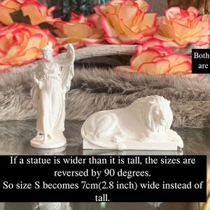 May include: Two white statues, a woman and a lion, are displayed on a fuzzy gray surface. Both statues are size S. The text below the statues reads: "If a statue is wider than it is tall, the sizes are reversed by 90 degrees. So size S becomes 7cm(2.8 inch) wide instead of tall."