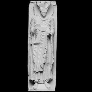 May include: A detailed, white stone carving of a robed figure holding a scroll. The figure has a beard and is standing within a rectangular frame. The carving is highly detailed, with visible folds in the robes and intricate facial features.