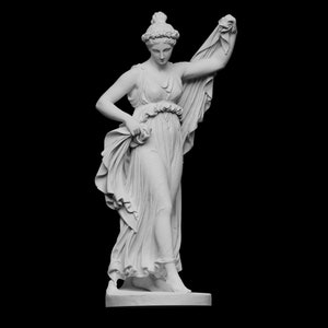 May include: White marble statue of a woman in a flowing robe, standing with one hand raised and holding a piece of fabric.