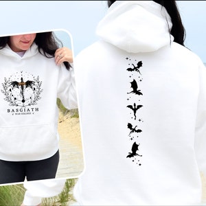 May include: White hoodie with a black dragon design on the back and a black and white dragon design on the front. The front design includes the text "BASGIATH WAR COLLEGE".