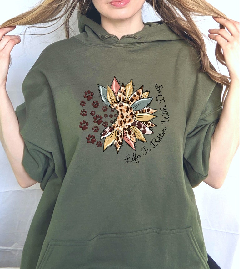 May include: A green hooded sweatshirt with a graphic of a sunflower with paw prints and the text "Life Is Better With Dogs".