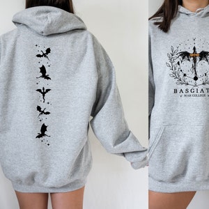 May include: Grey hooded sweatshirt with a black dragon design on the back and a black dragon with the text "BASGIATH WAR COLLARGE" on the front.