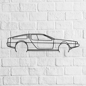 May include: Black outline of a DeLorean car against a white brick wall. The car's iconic gull-wing doors and distinct body shape are clearly visible. The artwork is a minimalist design, perfect for automotive enthusiasts.