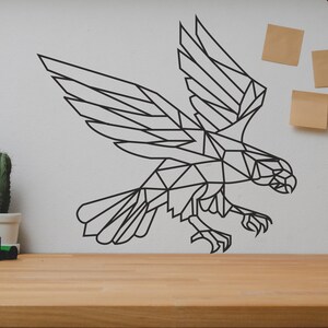May include: A black geometric design of a bird in flight on a white wall. The bird is made of triangles and has a sharp beak. The design is a wall decal.