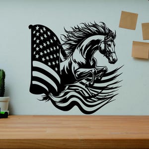 May include: Black and white graphic of a horse leaping in front of an American flag. The horse has a flowing mane and tail. The flag has stars and stripes. The image is on a white wall.