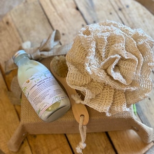 Può includere: Un set regalo di cura della pelle naturale con una bottiglia trasparente di detergente, tonico e struccante 3 in 1, uno spazzolino di legno e una spugna di luffa naturale in un cesto di juta.