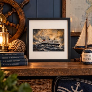 May include: A framed print featuring a white and black ferry navigating choppy, dark blue ocean waves under a dramatic, cloudy sky. The ship displays the text Caledonian MacBrayne on its side, with a faint map overlay showing route lines.