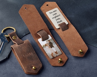 May include: A brown leather keychain with a photo insert and a metal tag that says "No one can replace you, Dad".