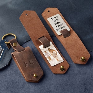 May include: A brown leather keychain with a photo insert and a small card that says "Drive safe babe, I need you here".