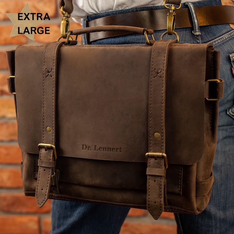 A close-up image of a brown leather satchel with the name "Dr. Lennert" printed on it.