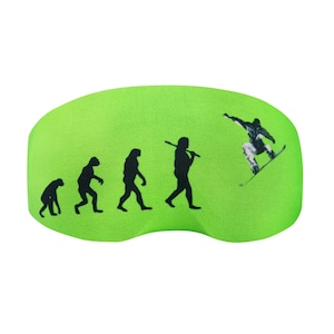 May include: Green ski goggle with a black and white graphic of the evolution of man, ending with a snowboarder.