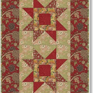 Pode incluir: Um bloco de colcha com um padrão de estrela vermelha, verde e dourada. A estrela é cercada por uma borda de quadrados menores com padrões florais.