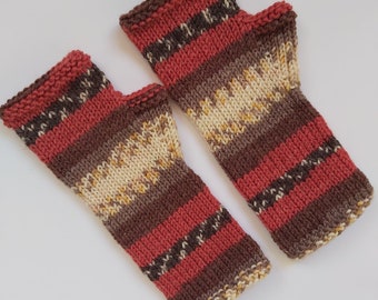 May include: A pair of knitted fingerless gloves with a striped pattern in shades of brown, red, and cream.