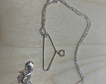 Miniature silver plated clothes hanger necklace for the politically aware and prochoice woman. Nickle free jewelry.