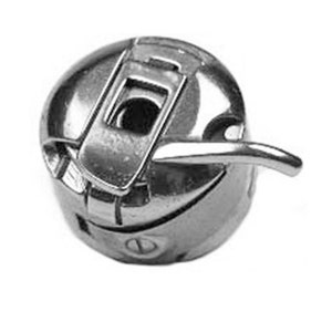May include: A silver bobbin winder for a sewing machine. The winder has a lever and a small opening for thread.